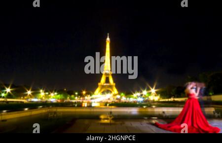 Blurred Image,  Romantic eiffel tower in paris with blurred couple ask marry in background, France by night, Eiffel Tower with light performance show, Stock Photo