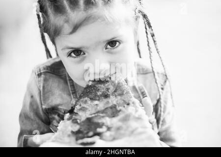 Child eating pizza. Fastfood for kids. Junkfood addiction. Italian cuisine. Children food. Childhood obesity. Tasty food for kid. Stock Photo