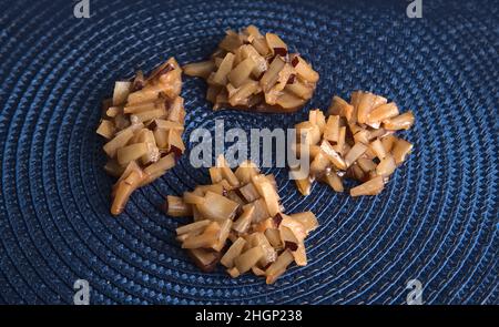Jamaican coconut drops on a dark blue straw mat Stock Photo