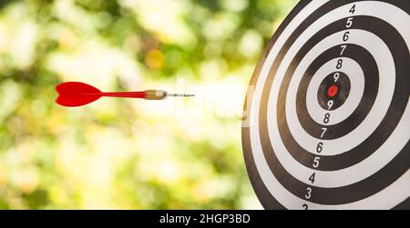 New Target and goal as concept, Close up shot of the dart arrow hit on bullseye, red dart arrow hitting in the target center of dartboard Target hit i Stock Photo