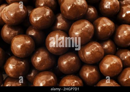 Chocolate milk balls. Background of a large number of brown chocolate balls Stock Photo
