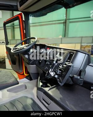 Interior of a dump truck cabin: seat, wheel, dashboard. Stock Photo