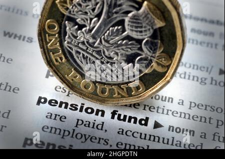 DICTIONARY DEFINITION OF WORDS PENSION FUND WITH ONE POUND COIN RE PENSIONS RETIREMENT COST OF LIVING RISING PRICES SAVINGS PENSIONERS ETC UK Stock Photo