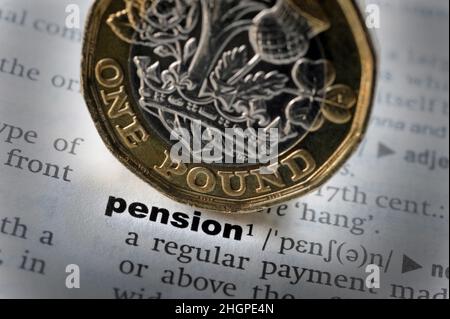 DICTIONARY DEFINITION OF WORD PENSION WITH ONE POUND COIN RE PENSIONS RETIREMENT COST OF LIVING RISING PRICES SAVINGS PENSIONERS ETC UK Stock Photo
