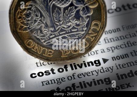 DICTIONARY DEFINITION OF WORDS COST OF LIVING WITH ONE POUND COIN RE PENSIONS RETIREMENT COST OF LIVING RISING PRICES SAVINGS PENSIONERS ETC UK Stock Photo