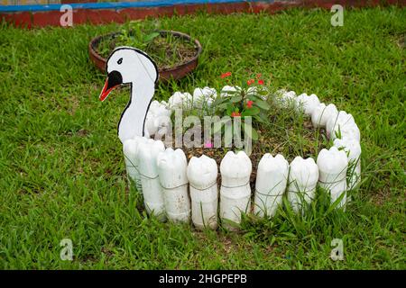 Recycled plastic bottles in flowerpot in Leticia, Amazonia, Colombia Stock Photo