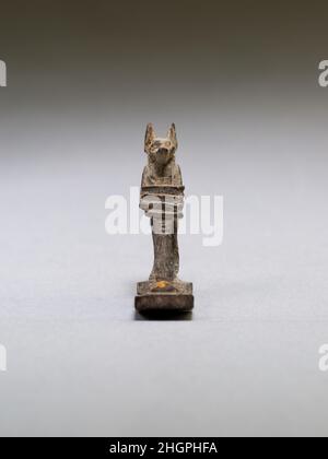 Anubis (?) supporting a large djed pillar 664–30 B.C. Late Period–Ptolemaic Period The small, finely detailed mulets 10.130.2439-.2445 are all made of wood. Wooden amulets are often gilded, but the only remaining gilding is on the goddess's sun disk.. Anubis (?) supporting a large djed pillar. 664–30 B.C.. wood. Late Period–Ptolemaic Period. From Egypt Stock Photo