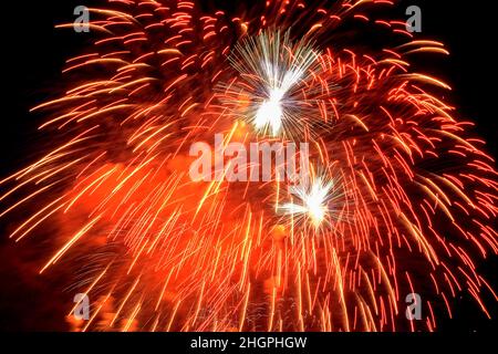 Backgrounds from festive fireworks. Fireworks in the night sky in honor of Victory Day. Stock Photo
