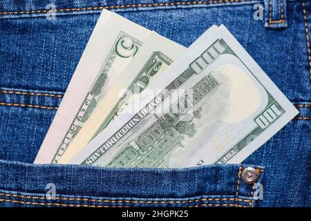 Dollars stick out of the pocket of jeans. Money in your pocket. Stock Photo
