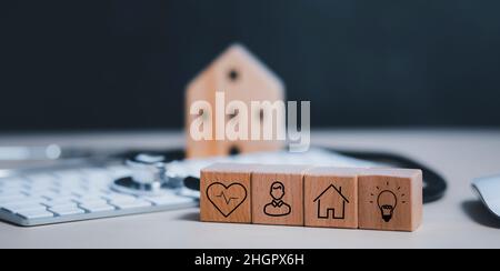 Wooden blocks with icons of various types of insurance, icons healthcare ,Doctor Stethoscope isolated on white with a modern computer keyboard,Virus s Stock Photo