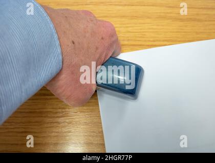 Norwich, Norfolk, UK – January 2022. Sheets of white paper in a Rapid branded stapler Stock Photo