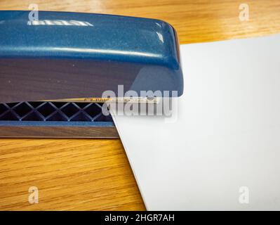 Norwich, Norfolk, UK – January 2022. Sheets of white paper in a Rapid branded stapler Stock Photo