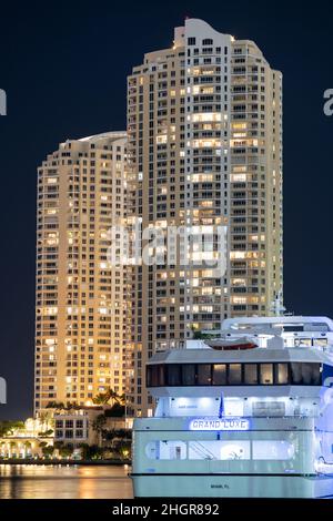 Night photo Grand Luxe charter yacht with view of Brickell in background Stock Photo