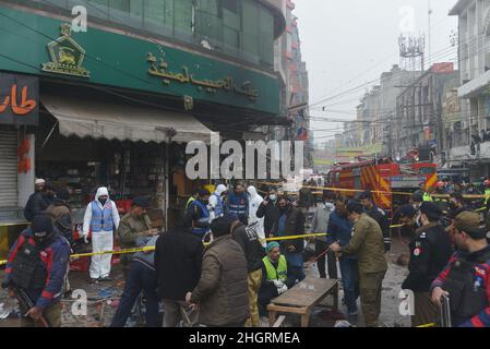 Lahore, Pakistan. 20th Jan, 2022. Pakistani investigators gather evidence as they examine the site of a bomb explosion in Lahore, Pakistan, on January 20, 2022.Police said the powerful bomb exploded in a crowded Anarkali bazar in Pakistan's second largest city of Lahore. At least four people were killed and 28 injured in a blast, officials said. (Photo by Rana Sajid Hussain/Pacific Press/Sipa USA) Credit: Sipa USA/Alamy Live News Stock Photo