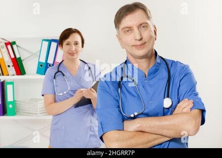Doctor and nurse posing in medical office close up. Two doctors closeup in clinic Stock Photo