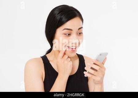 smiling woman hold cellphone. Closeup young happy beautiful asian japanese woman. Girl looking at mobile cellphone isolated on white background. Posit Stock Photo