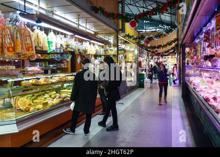 People shopping in the covered market 'Antica Tettoia dell'Orologio' of Porta Palazzo in Piazza della Repubblica, Turin, Piedmont, Italy Stock Photo