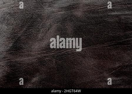 Brown leather texture. Worn piece of leather closeup Stock Photo