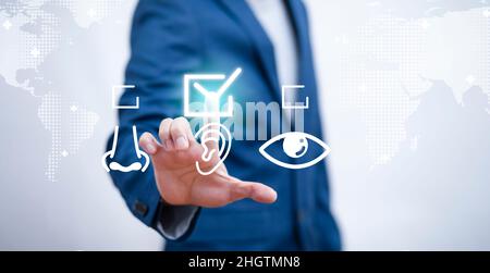 Businessman touch choose ear health on the map background,General Medical Services Concept, pressing the virtual button on service touchscreen by his Stock Photo