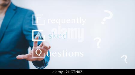 Businessman clicking FAQ or Frequently asked questions button on search toolbar, FAQ sign connection icon web communication, concept for website servi Stock Photo