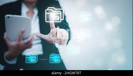 Businesswoman hand touch folder of document Management System,  online documentation database and process automation to efficiently manage files work, Stock Photo