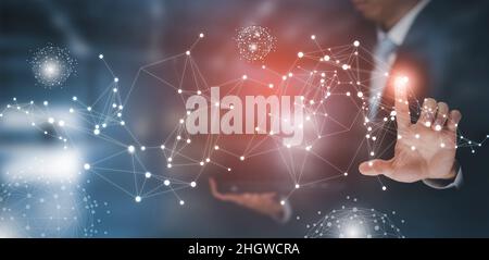 Businessman holding connections system and global data exchange. ,Business network connection concept. hologram screen displaying modern web system Wi Stock Photo