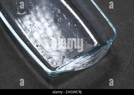 A baking dish cleaned from a thick layer of carbon. Glassware for baking after washing with a steam cleaner. Stock Photo