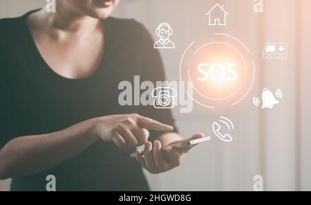 Woman using Smart Phone with Emergency app in home, call phone, Chat message icon, Emergency application from smartphone for elderly, technology conce Stock Photo