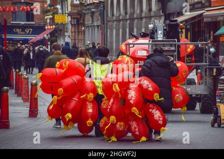 London, UK 22nd January 2022. Workers carry new lanterns to be installed in Chinatown ahead of Chinese New Year. Credit: Vuk Valcic / Alamy Live News Stock Photo