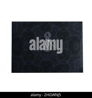String envelope in vintage style isolated on white background. Black kraft paper with floral pattern. Stock Photo