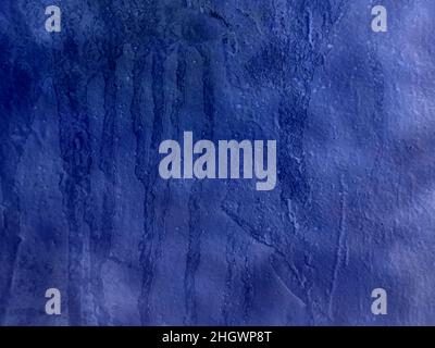 Old wall with irregular pattern. Harsh surface in blue tones. Grunge background best for wallpaper. Stock Photo