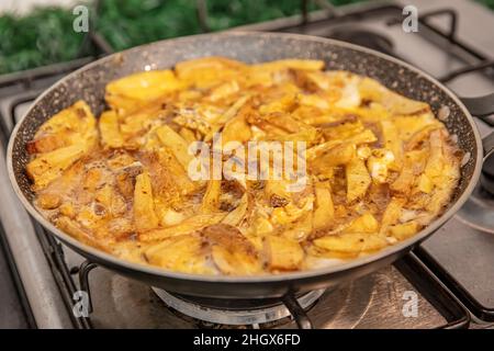 Sliced Spanish potato omelette in pan, selective focus. Potato Egg and Onion Omelette known locally as an Spanish Tortilla. It is called 'Patatesli Om Stock Photo