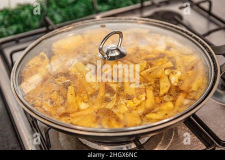 Sliced Spanish potato omelette in pan, selective focus. Potato Egg and Onion Omelette known locally as an Spanish Tortilla. It is called "Patatesli Om Stock Photo