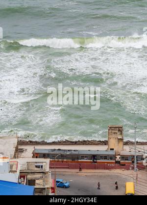 Train at Kollupitiya Railway Station in Colombo, Sri Lanka with the Laccadive Sea in the background. The station is one of the busiest railway station Stock Photo