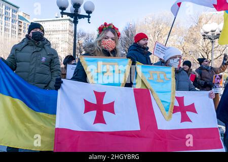 NEW YORK, NY - JANUARY 22: Women hold the Georgian flag at a Stand With Ukraine rally in Union Square on January 22, 2022 in New York City.    Members of the Russian-speaking diaspora and Ukrainian activists demonstrated amid threat of Russian invasion of the Ukraine.  Ukraine and Russia have been in conflict since Putin responded to the 2014 Ukrainian revolution that ousted the pro-Moscow president by seizing Crimea. Stock Photo