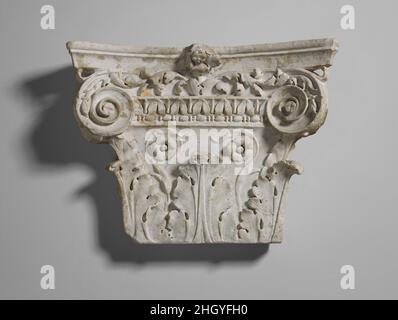 Marble pilaster capital 1st half of 1st century A.D. Roman The capital was once set against a wall, crowning a rectangular semi-detached pilaster. In Roman architecture three major orders of capitals were used—Doric, Ionic, and Corinthian. This pilaster capital is a fine example of the most elaborate, the Corinthian order. Three acanthus leaves rise from the base and two flowers on delicately carved stems curl upward between them. A classical molding with stylized lotus flowers over a band of bead and reel separates the lower part of the capital from the two volutes around which a leafy vine e Stock Photo