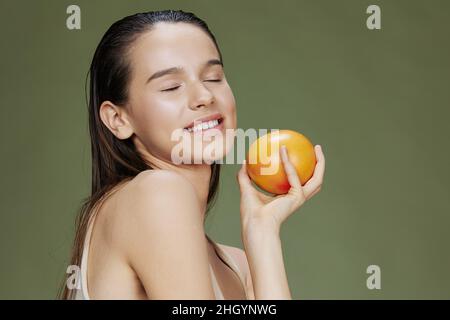 beautiful woman grapefruit in hands posing clean skin isolated background Stock Photo