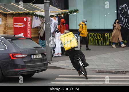 Bucharest, Romania - January 13, 2022: A Glovo food delivery courier delivers food in Bucharest, Romania. Stock Photo