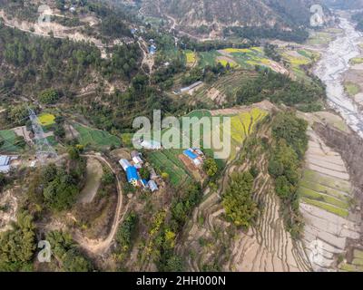 An aerial view of terraces and fields on a hillside in Nepal. Stock Photo