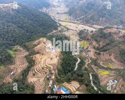 An aerial view of terraces and fields on a hillside in Nepal. Stock Photo