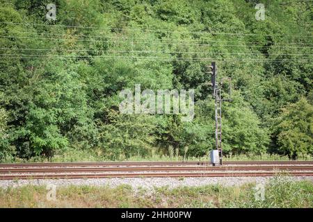 Picture of a railroad traffic light, a signaling system, old and decayed, on arailway line, electrified track. Stock Photo
