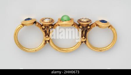 Gold triple finger ring 3rd 4th century A.D. Roman Syrian This ring exemplifies a flamboyant type of costume jewelry that was especially popular in the eastern half of the Roman Empire. The three fing...