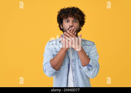 Shocked surprised young indian man isolated on yellow background. Stock Photo