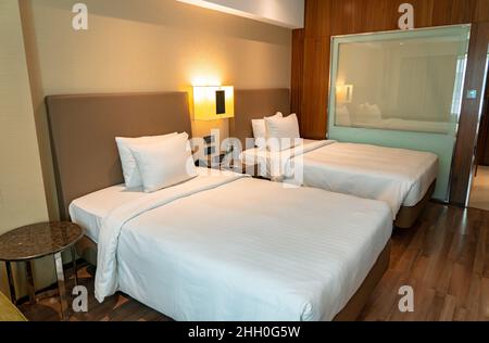 A modern luxury hotel room with a see through bathroom. Stock Photo