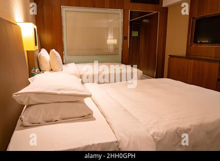 The deluxe room at the Courtyard Marriott Chennai provides two luxury twin beds with space and comfort for business and leisure travelers. Stock Photo