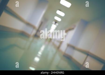 Unfocused angled background with long hallway of a modern building. Stock Photo