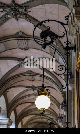 Baroque style covered arcade and ornate metal art nouveau light fixture in Porto, Portugal Stock Photo