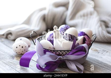 Easter composition with eggs, decorated with purple sparkles. Stock Photo
