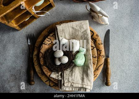 Easter dinner table settinf with colored eggs served on the table Stock Photo