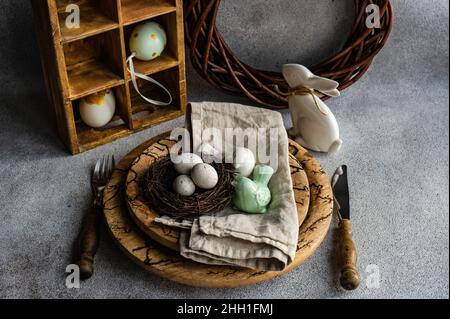 Easter dinner table settinf with colored eggs served on the table Stock Photo